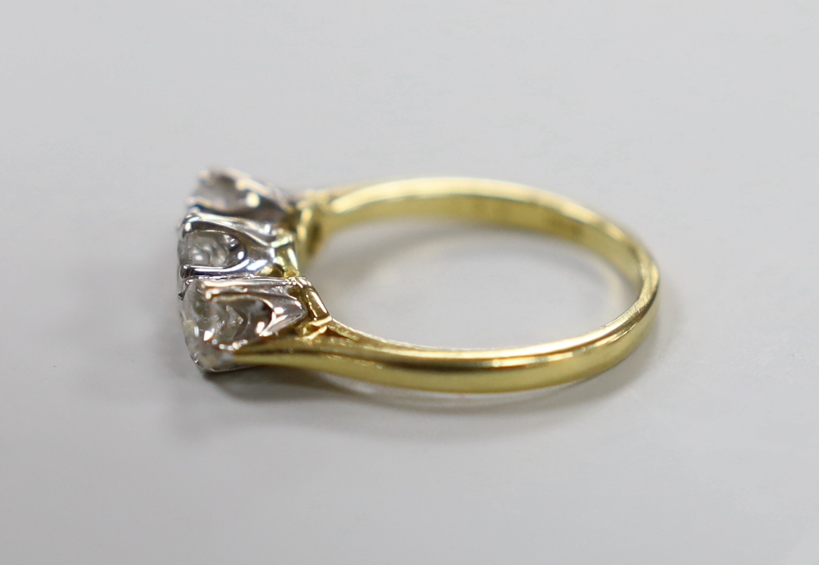 A 1970's 18ct gold and three stone diamond set ring, size O/P, gross weight 4.7 grams